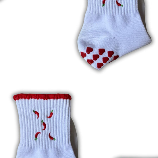  Red and white non slip grip socks with chilies embordered on them and red heart grips